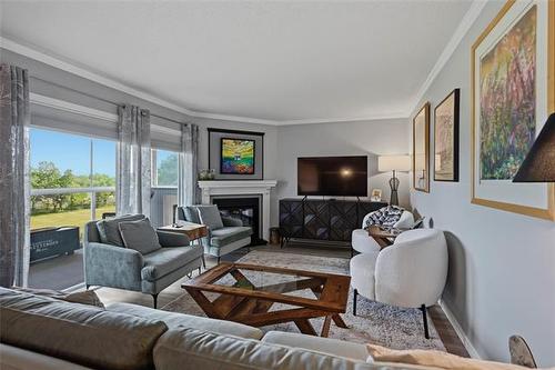 308-70 Dunkirk Dr, Winnipeg, MB - Indoor Photo Showing Living Room With Fireplace