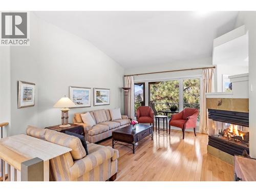 Living room with fireplace. - 4400 Gallaghers Drive E Unit# 2, Kelowna, BC - Indoor Photo Showing Living Room With Fireplace