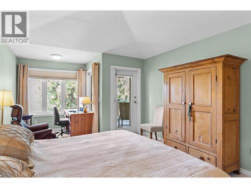 Primary bedroom with access to view deck. - 4400 Gallaghers Drive E Unit# 2, Kelowna, BC - Indoor Photo Showing Bedroom