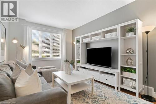 Expansive window with blinds and sheer drapery - 711 Angler Way, Waterloo, ON - Indoor Photo Showing Living Room
