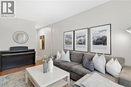 Light gray wall paint, recessed lighting, wood-finish flooring, and a white ceiling - 711 Angler Way, Waterloo, ON - Indoor Photo Showing Living Room