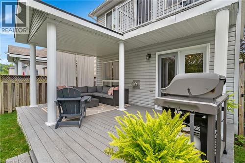 Expansive covered deck featuring a textured surface, multiple support columns, and privacy screens - 711 Angler Way, Waterloo, ON - Outdoor With Deck Patio Veranda With Exterior
