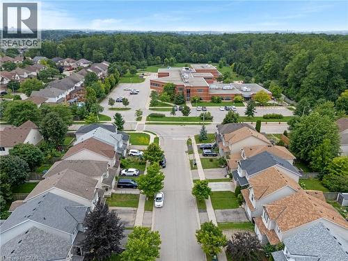 Residential development featuring varied rooflines, paved streets, and mature trees - 711 Angler Way, Waterloo, ON - Outdoor With View
