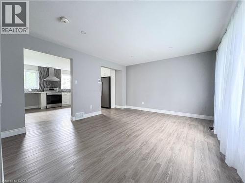 Spacious room featuring wood-finish flooring, recessed lighting, and light gray wall paint - 216 Brunswick Crescent, London, ON - Indoor Photo Showing Other Room