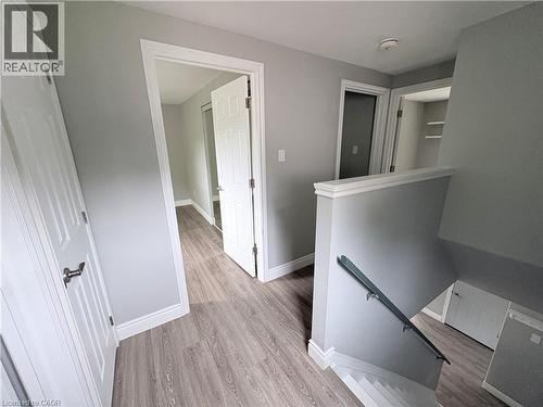 Wood-finish flooring throughout, with white trim and doors - 216 Brunswick Crescent, London, ON - Indoor Photo Showing Other Room