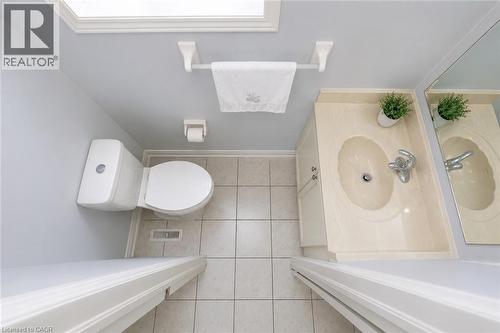 Recessed sink vanity, large wall-mounted mirror, white toilet, and tiled flooring - 1793 Creek Way, Burlington, ON - Indoor Photo Showing Bathroom