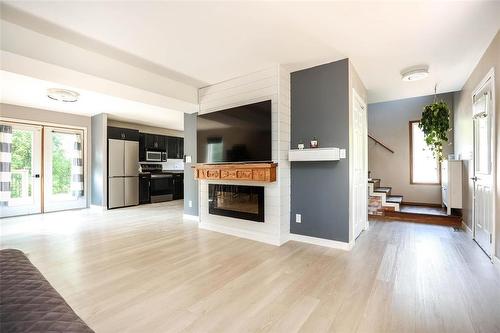 20 Son Crescent, Rosser, MB - Indoor Photo Showing Other Room With Fireplace