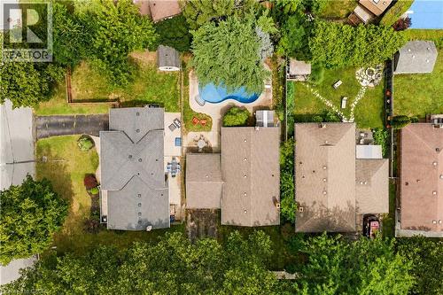 Residential property featuring a grey shingled roof, paved driveway, and established front landscaping - 11 Kimbermount Drive, St. Catharines, ON - Outdoor With View