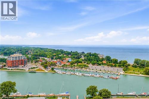Aerial perspective showcasing a vibrant waterfront community with a marina, body of water, and surrounding greenery - 11 Kimbermount Drive, St. Catharines, ON - Outdoor With Body Of Water With View