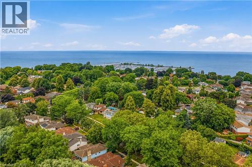 Aerial perspective showcasing a residential area with mature trees - 11 Kimbermount Drive, St. Catharines, ON - Outdoor With Body Of Water With View