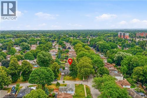 Aerial overview showcasing the property with surrounding mature trees and a residential neighborhood - 11 Kimbermount Drive, St. Catharines, ON - Outdoor With View