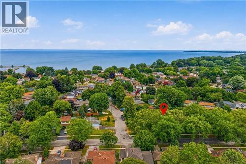 Aerial perspective showcasing a residential area with dense tree coverage and broad water frontage - 11 Kimbermount Drive, St. Catharines, ON - Outdoor With Body Of Water With View