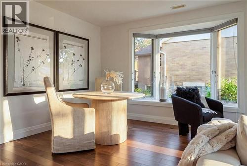 Hardwood-finish flooring, white walls, and a multi-pane bay window - 90 Dean Avenue, Guelph, ON - Indoor Photo Showing Other Room