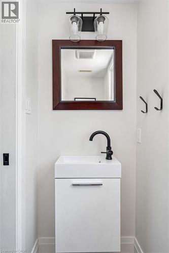 White floating vanity with integrated sink and matte black faucet - 90 Dean Avenue, Guelph, ON - Indoor Photo Showing Bathroom