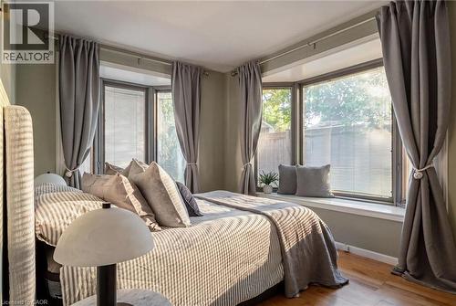 Bay window with integrated window seat, hardwood flooring, and neutral wall tones - 90 Dean Avenue, Guelph, ON - Indoor Photo Showing Bedroom