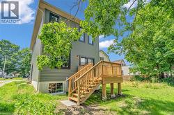 Multi-story exterior with horizontal siding and black-trimmed windows - 