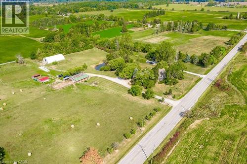 Expansive green acreage featuring multiple outbuildings, a private pond, and direct road frontage - 2108 Westbrook Road, Binbrook, ON 