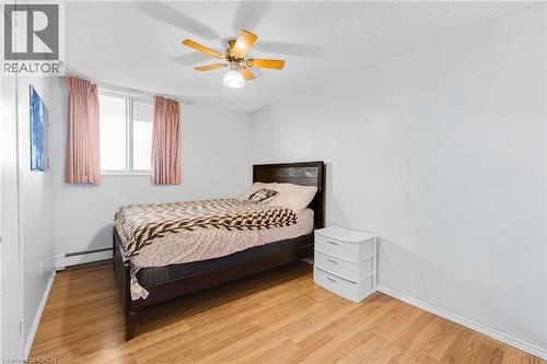 Wood-finish flooring, white walls, and a ceiling fan with integrated lighting - 975 Warwick Court Unit# 708, Burlington, ON - Indoor Photo Showing Bedroom