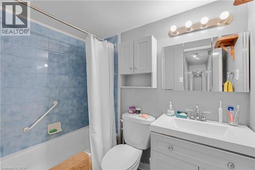Bathroom featuring a vanity with an integrated sink, tri-fold mirrored medicine cabinet, and overhead light fixture - 975 Warwick Court Unit# 708, Burlington, ON - Indoor Photo Showing Bathroom