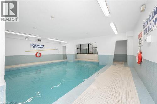 Indoor swimming pool with light blue and white tile accents - 975 Warwick Court Unit# 708, Burlington, ON - Indoor Photo Showing Other Room