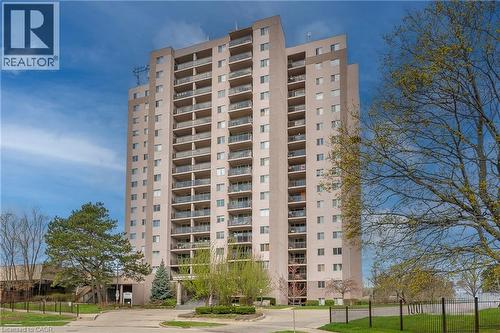 Multi-story residential building featuring numerous private balconies with glass railings - 975 Warwick Court Unit# 708, Burlington, ON - Outdoor With Balcony With Facade