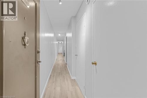 Entry corridor featuring wood-finish flooring and track lighting - 975 Warwick Court Unit# 708, Burlington, ON - Indoor