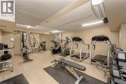 State-of-the-art fitness facility featuring multiple cardio machines, strength training equipment, and functional exercise stations - 975 Warwick Court Unit# 708, Burlington, ON - Indoor Photo Showing Gym Room