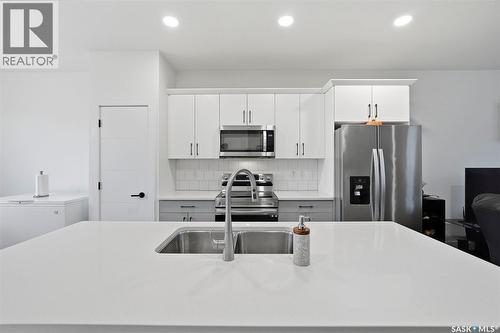 132 Rosewood Boulevard E, Saskatoon, SK - Indoor Photo Showing Kitchen With Stainless Steel Kitchen With Double Sink With Upgraded Kitchen