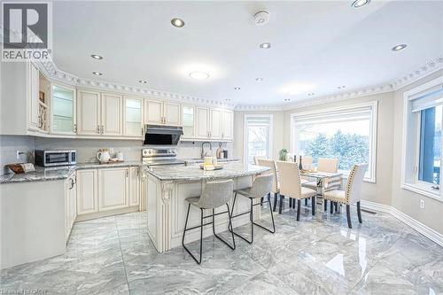 Eat-in kitchen featuring white cabinetry, granite countertops, stainless steel appliances, and tile flooring - 247 Sand Road, Holland Landing, ON - Indoor