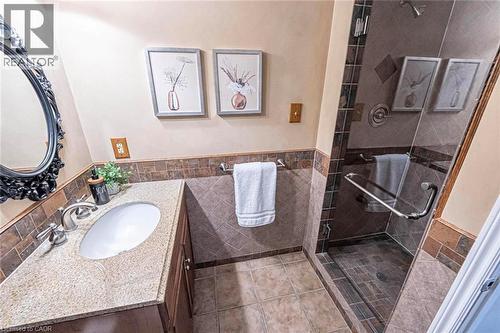 Bathroom featuring a single vanity with a granite-style countertop, undermount sink, and brushed nickel fixtures - 247 Sand Road, Holland Landing, ON - Indoor Photo Showing Bathroom