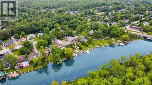 Waterfront properties with private docks, lush green surroundings, and mature trees lining the riverbank - 247 Sand Road, Holland Landing, ON - Outdoor With Body Of Water With View