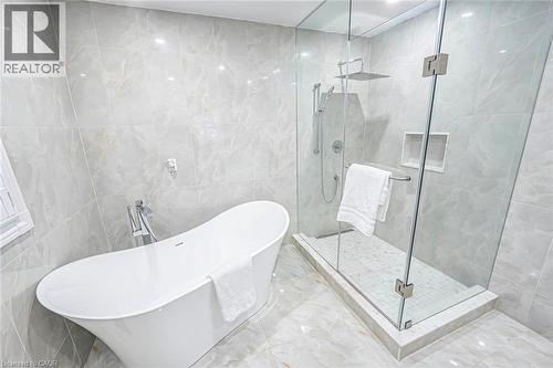 Freestanding soaking tub and glass-enclosed shower with rain shower head - 247 Sand Road, Holland Landing, ON - Indoor Photo Showing Bathroom