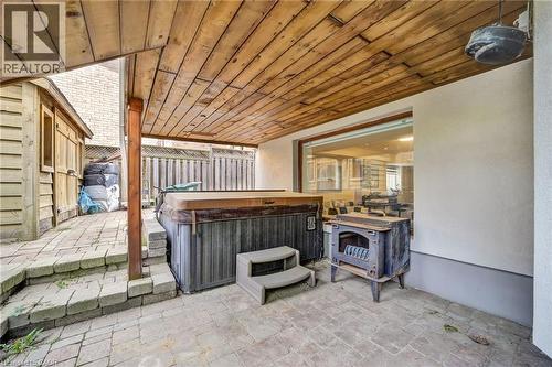 Covered patio featuring a wood-finish ceiling, brick paver flooring, and a built-in hot tub - 247 Sand Road, Holland Landing, ON - Outdoor With Exterior
