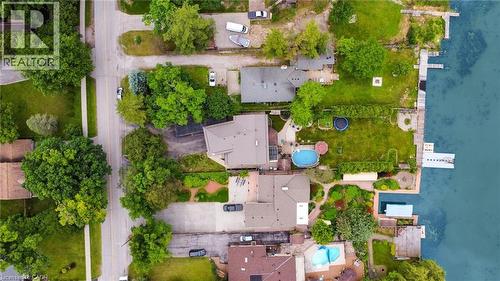 Waterfront property featuring a private dock, expansive green space, and a swimming pool - 247 Sand Road, Holland Landing, ON - Outdoor With Body Of Water With View