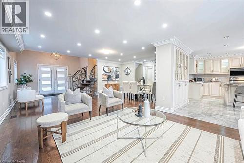Open-concept living area featuring rich wood-finish flooring, recessed lighting, and ornate crown molding - 247 Sand Road, Holland Landing, ON - Indoor
