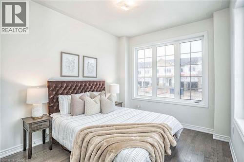 Hardwood-finish flooring, white painted walls, multi-pane window, flush mount ceiling light - 525 Red Elm Road, Shelburne, ON - Indoor Photo Showing Bedroom
