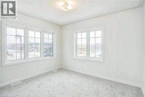 Light-toned wall finishes, light grey carpet, and flush mount ceiling lighting - 525 Red Elm Road, Shelburne, ON - Indoor Photo Showing Other Room