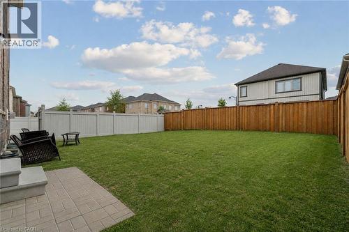 Expansive green lawn with a paver patio and a mix of wood and vinyl fencing - 525 Red Elm Road, Shelburne, ON - Outdoor