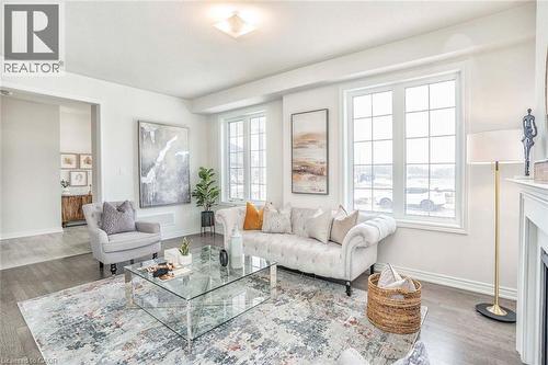 Bright living space featuring wood-finish flooring, white walls, and a recessed ceiling light fixture - 525 Red Elm Road, Shelburne, ON - Indoor Photo Showing Living Room With Fireplace