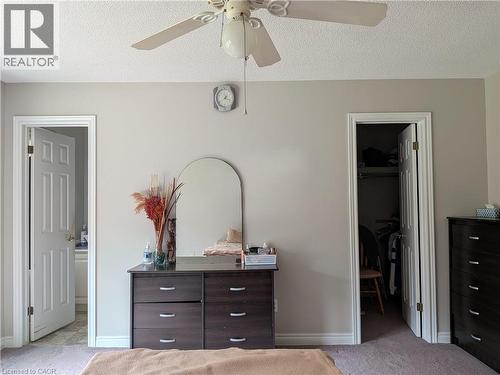 Neutral wall paint, ceiling fan light fixture, arched mirror, recessed closet, and paneled interior doors - 45 Caswell Drive Unit# Upper, Hamilton, ON - Indoor Photo Showing Bedroom