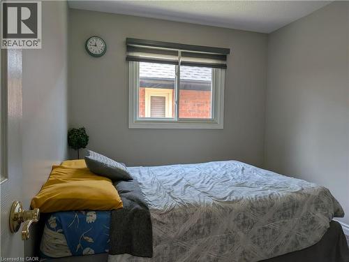 White framed window with privacy blinds - 45 Caswell Drive Unit# Upper, Hamilton, ON - Indoor Photo Showing Bedroom