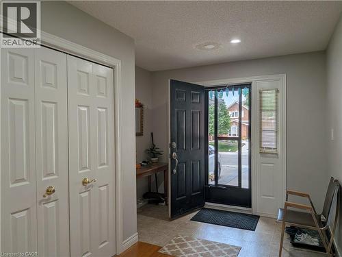 Entryway featuring tile flooring, a six-panel front door with a screen door, and a sidelight with blinds - 45 Caswell Drive Unit# Upper, Hamilton, ON - Indoor Photo Showing Other Room