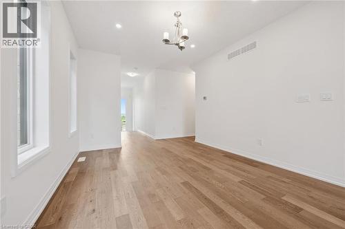 Recessed lighting, wood-finish flooring, and a chandelier light fixture - 451 Benninger Street, Kitchener, ON 
