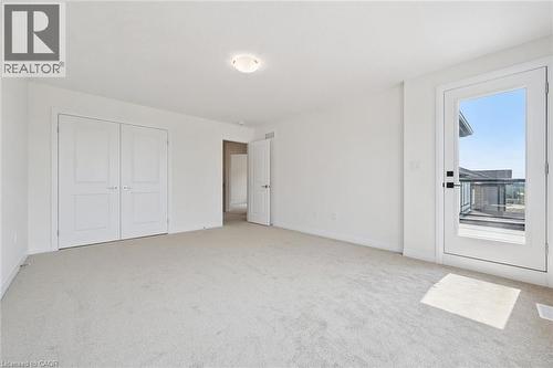 Light-colored carpeting, white walls, and a white ceiling with a flush-mount light fixture - 451 Benninger Street, Kitchener, ON 
