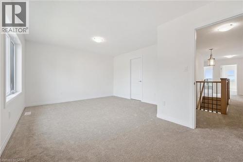 Plush carpet flooring, bright white walls, and a large window - 451 Benninger Street, Kitchener, ON 