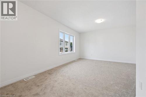 Recessed ceiling lighting, white walls, light-colored carpeting, multiple window panes, and white trim - 451 Benninger Street, Kitchener, ON 
