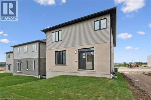 Contemporary exterior featuring light brick and horizontal siding - 451 Benninger Street, Kitchener, ON 