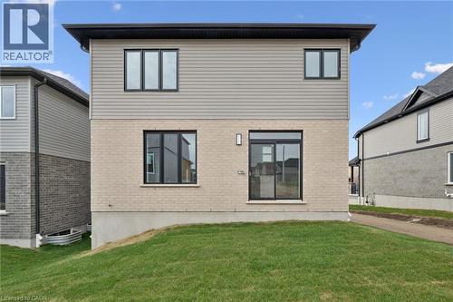 Two-story exterior featuring light-toned brick and horizontal siding - 451 Benninger Street, Kitchener, ON 