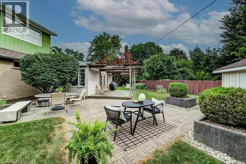 Expansive backyard featuring a brick paver patio, a concrete patio, and a pergola-covered deck - 97 Somerset Crescent, Waterloo, ON - Outdoor