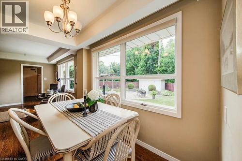 Dining area featuring wood-finish flooring and a multi-bulb chandelier - 97 Somerset Crescent, Waterloo, ON - Indoor Photo Showing Dining Room
